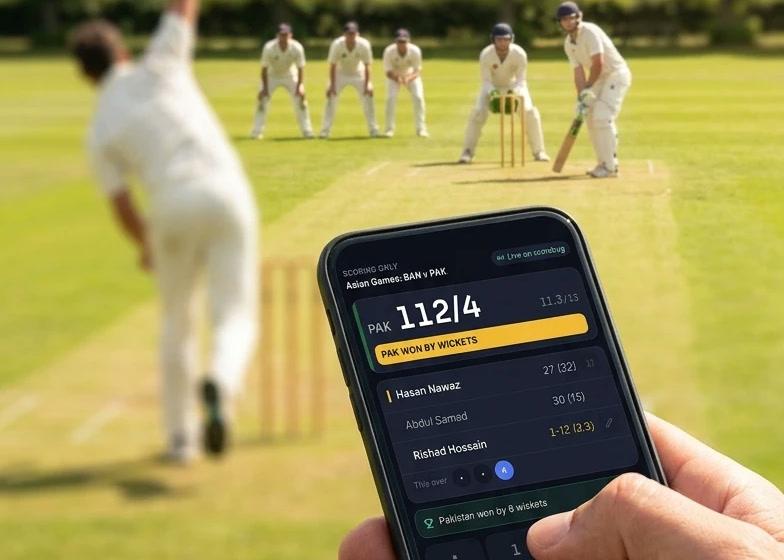 Scoring a cricket match ball by ball on a phone at the boundary